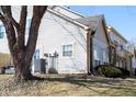 Back exterior view of the two-story home showcasing white siding and a well maintained yard at 2449 Chaseway Ne Ct # Blk B, Indianapolis, IN 46268