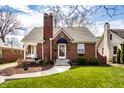Attractive brick home with a manicured lawn, walkway, and charming architectural details at 2615 Kessler Blvd E Dr, Indianapolis, IN 46220