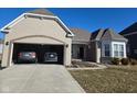 Inviting single-story home with brick detailing, attached garage, and cozy front porch entrance and manicured lawn at 2625 Kilgobbin Cres, Brownsburg, IN 46112