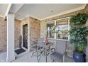 Inviting front porch with seating area, decor, and stylish brickwork creates a welcoming entrance at 3203 S Cordell Rd, New Palestine, IN 46163