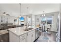Modern kitchen featuring an island with a sink, a breakfast bar, stainless steel appliances, and an open floor plan at 3203 S Cordell Rd, New Palestine, IN 46163
