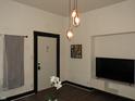 Modern living room featuring stylish lighting, dark trim and wood-look floors at 3610 E 28Th St, Indianapolis, IN 46218