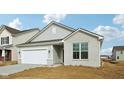 Attractive single-story home featuring a two-car garage and white brick accents at 4825 Topaz Pointe Blvd, Lawrence, IN 46235