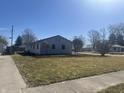 View of the large front yard of a single story home with bare trees at 504 Iroquois Dr, Anderson, IN 46012