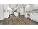 Open-concept kitchen featuring white cabinets, granite countertops, and hardwood floors at 5214 Woodfield Dr, Carmel, IN 46033