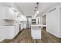 Bright, modern kitchen with white cabinets, stainless steel appliances, and a center island with seating at 5214 Woodfield Dr, Carmel, IN 46033