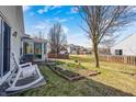 Well-maintained back yard featuring lush green grass, a cozy patio, and a fenced perimeter at 5462 Wilder Way, Indianapolis, IN 46216