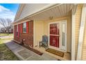 Charming covered front porch with decorative chair and doormat at entryway at 5462 Wilder Way, Indianapolis, IN 46216