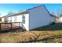 Exterior rear view of home featuring a wood deck, window, and neutral siding at 6221 Cradle River Dr, Indianapolis, IN 46221