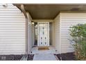Front door with storm door with decorative windows and 'welcome home' doormat at 6454 Bay Harbor Ln, Indianapolis, IN 46254