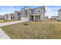 Charming two-story home with blue siding, brick accents, a two-car garage, and a well-manicured front lawn at 6713 Cardiff Dr, McCordsville, IN 46055