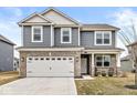 Charming front porch with brick columns and two comfortable chairs at 6713 Cardiff Dr, McCordsville, IN 46055