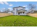 Large backyard with a full fence, providing privacy and a safe area for outdoor activities and entertainment at 711 N Fenton Ave, Indianapolis, IN 46219