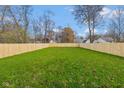Spacious backyard with new wooden fence and lush green grass, perfect for outdoor activities at 711 N Fenton Ave, Indianapolis, IN 46219