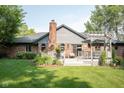 Spacious backyard with a deck, brick chimney, and mature trees, perfect for entertaining at 7971 Clearwater Ct, Indianapolis, IN 46256