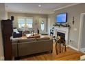 Bright living room featuring a fireplace, plush seating, and natural light from the front door at 8960 Stepping Stone Way, Avon, IN 46123