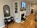 Inviting living room with a fireplace, built-in shelves, and wood floors at 8960 Stepping Stone Way, Avon, IN 46123