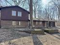 Exterior home view showing brick facade and a three-car garage at 8985 Huggin Hollow Rd, Martinsville, IN 46151