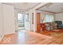 The inviting entryway features gleaming hardwood floors and vintage wallpaper at 1040 E Buchanan St, Plainfield, IN 46168