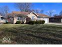 Inviting single-story house with a well-kept lawn and an attached garage at 1040 E Buchanan St, Plainfield, IN 46168
