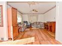 Bright living room with hardwood floors, vintage wallpaper, and comfortable seating at 1040 E Buchanan St, Plainfield, IN 46168