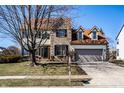 Charming two-story home featuring a brick and siding facade, attached two-car garage, and well-maintained landscaping at 10628 Blackthorn Ct, Fishers, IN 46038