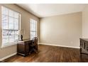 Office features hardwood floors, large windows, with a vintage desk and chair at 10628 Blackthorn Ct, Fishers, IN 46038