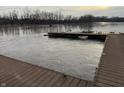 View of a partially submerged dock on a river with murky water, suggesting a possible flooding event at 10802 Giselle Way, Fishers, IN 46040