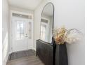 Bright foyer features a modern mirror, stylish cabinet, and beautiful decor at 11584 Glen Ridge Cir, Fishers, IN 46037