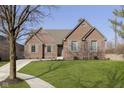 A well-maintained lawn surrounds a charming brick home with lovely curb appeal at 11584 Glen Ridge Cir, Fishers, IN 46037