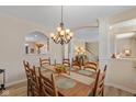 Bright and spacious dining room featuring hardwood floors, a view of the staircase, and modern chandelier at 13504 E 131St St, Fishers, IN 46037