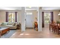 Bright living room with hardwood floors, neutral paint, and open floor plan, adjacent to dining area at 13504 E 131St St, Fishers, IN 46037
