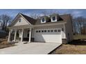 Charming single-story home with inviting front porch, attached garage, and a well-lit driveway at 14383 Coyote Ridge Dr, Noblesville, IN 46060