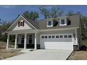 Charming single-Gathering home features a covered front porch and a two-car garage at 14383 Coyote Ridge Dr, Noblesville, IN 46060