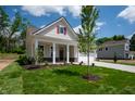 Charming home featuring a well-kept lawn, inviting front porch, and a two-car attached garage at 14383 Coyote Ridge Dr, Noblesville, IN 46060