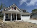 Charming single-Gathering home features a covered front porch and a two-car garage at 14383 Coyote Ridge Dr, Noblesville, IN 46060