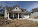 Charming single-story home with inviting front porch, attached garage, and a well-lit driveway at 14383 Coyote Ridge Dr, Noblesville, IN 46060