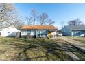 Inviting single-story home with a cozy front porch, updated roof, and convenient driveway parking at 1459 E Lynn Dr, Indianapolis, IN 46202