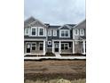 Street view showcasing charming new construction townhomes, each with unique colors and inviting front porches at 19493 Grassy Branch Rd, Westfield, IN 46074