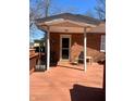View of covered deck with access to a brick home's exterior at 28 Cambridge Ct, Anderson, IN 46012