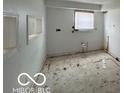 Unfinished room, ready for customization with a window, framing, and concrete floors at 2912 N Gladstone Ave, Indianapolis, IN 46218