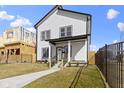Inviting two-story home with black fence and manicured lawn creating curb appeal at 35 N Keystone Ave, Indianapolis, IN 46201