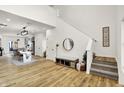 Open-concept living space with hardwood floors, high ceilings, and a staircase with neutral decor at 35 N Keystone Ave, Indianapolis, IN 46201