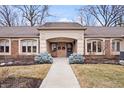 Exterior of brick condominium complex with walkway to unit entrances at 504 Bent Tree Ln, Indianapolis, IN 46260