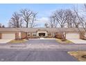 Brick condo complex with private driveways and attached garages in front at 504 Bent Tree Ln, Indianapolis, IN 46260
