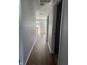 Hallway features light gray walls with white trim and durable laminate flooring throughout the home at 504 Elkhart Dr, Westfield, IN 46074