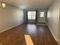 Bright living room featuring neutral walls, laminate flooring, and a window allowing plenty of natural light at 504 Elkhart Dr, Westfield, IN 46074