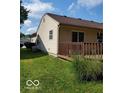 Tan house with small wooden back porch and grassy back yard at 5822 Blackley Ln, Indianapolis, IN 46254