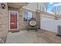 Cozy front porch area with a brick facade, an egg chair, and a charming front door at 5839 Beacon Cove Way, Indianapolis, IN 46237