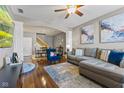 Spacious living room with hardwood floors, a blue accent chair, and an open archway to the dining area at 5839 Beacon Cove Way, Indianapolis, IN 46237